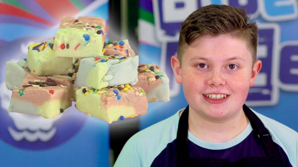 Junior Bake-Off winner Finn, alongside his unicorn fudge.