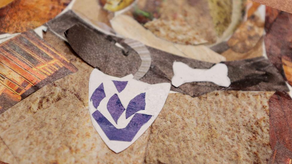A close-up of Henry's collar on the collage, featuring a buckle, loose end of the collar coming out of the buckle, a Blue Peter badge, and a bone.
