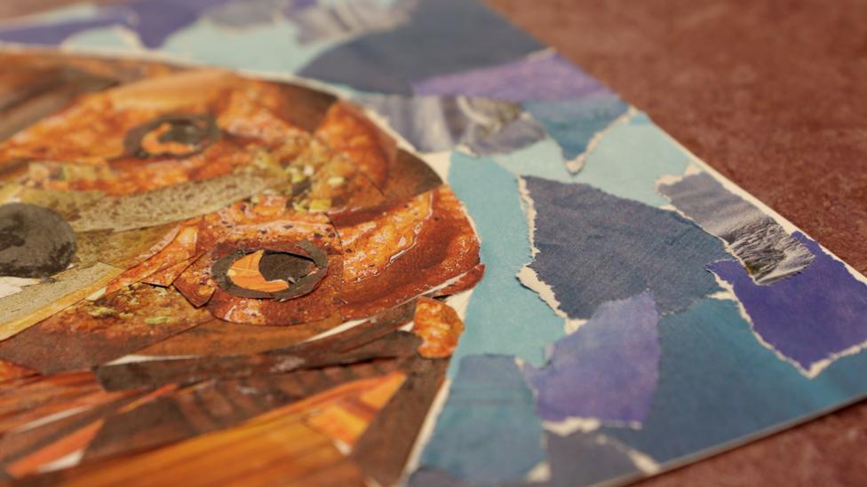 A close-up of the blue patchwork background around Henry.