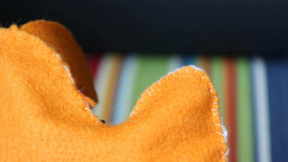 A close-up of Isla's stitching on the puppet.