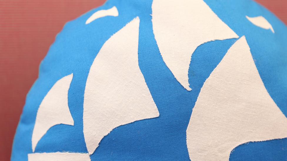 A close-up of the white BP ship stuck on to the cushion.