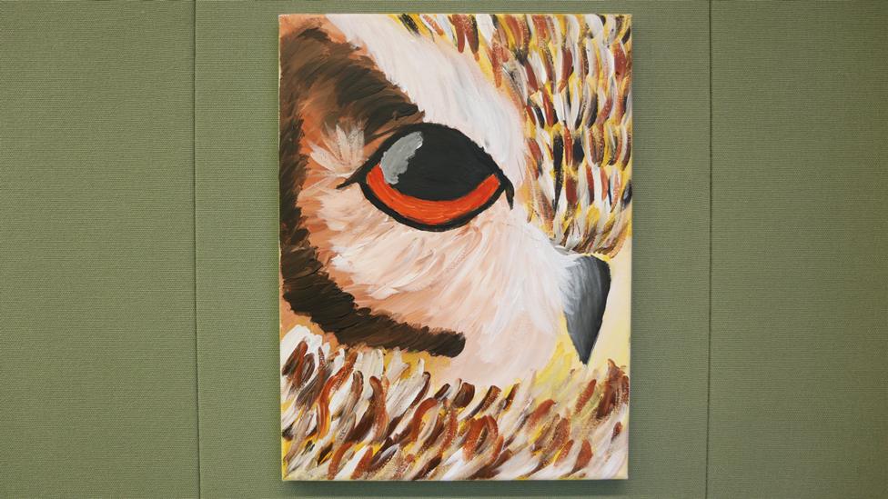 The owl painting in full. It depicts half of an owl's face, with the beak and one eye visible.