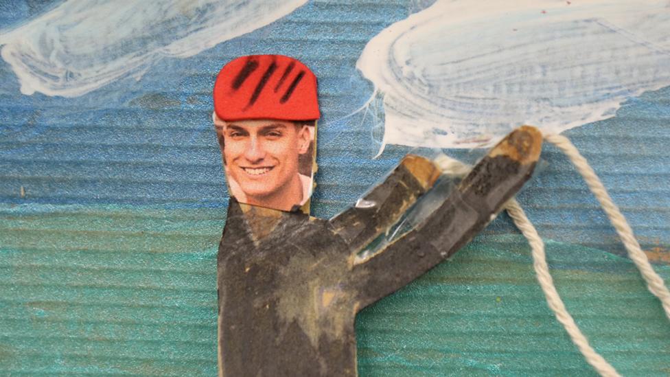 A close-up of the model of Richie, holding the strings of the kite.