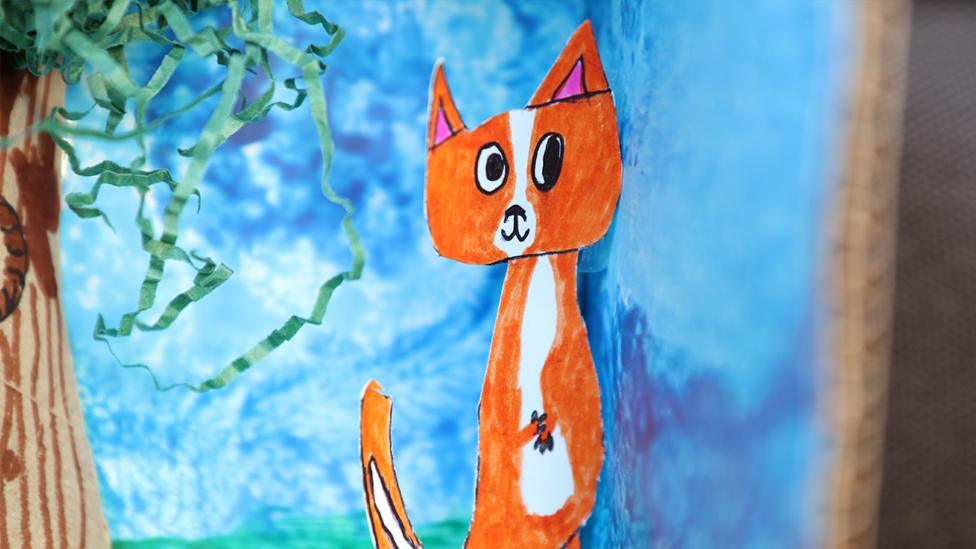 A close-up of the drawn fox, standing on two legs in the background.