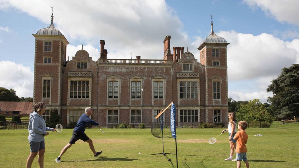 A wide shot of a grand house,
