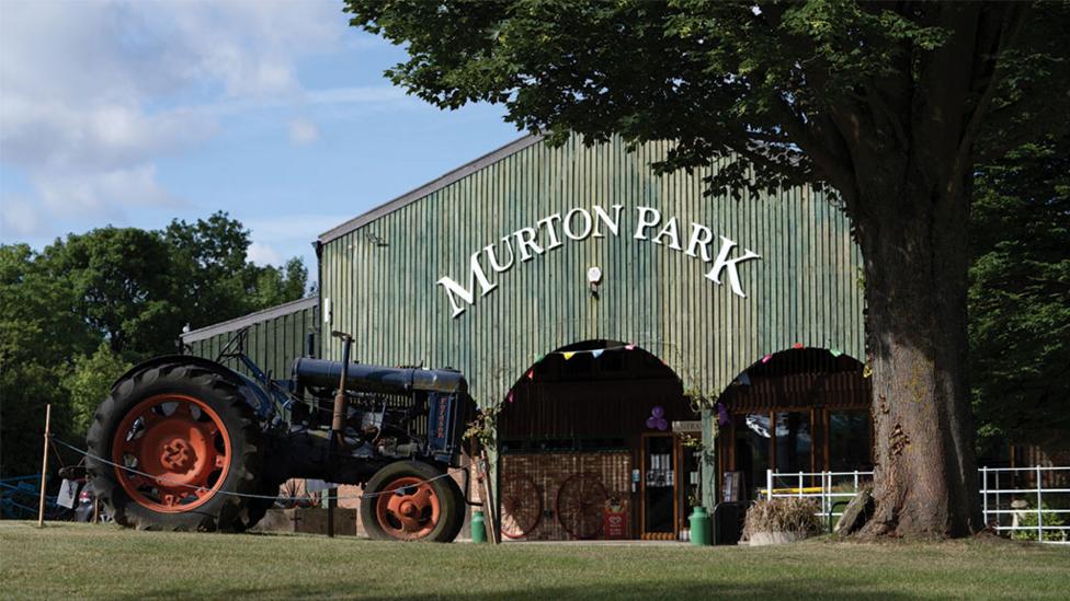 tractor-parked-outside-a-barn.