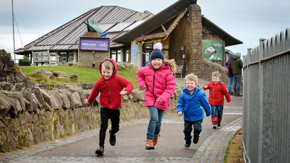 smiling-kids-running-outside.
