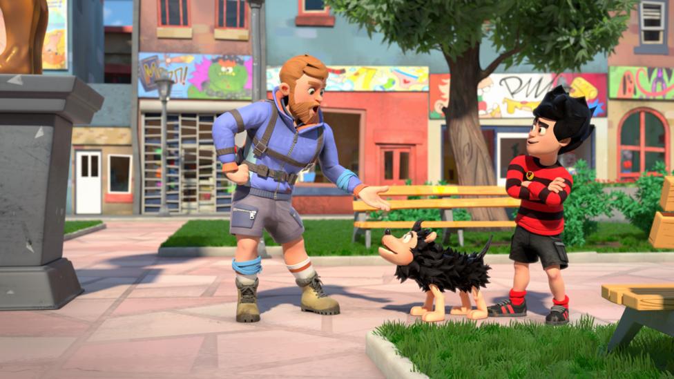 Dennis and Gnasher talk to another character in a park.