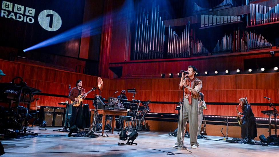 Harry Styles performs with his band in the Live Lounge.