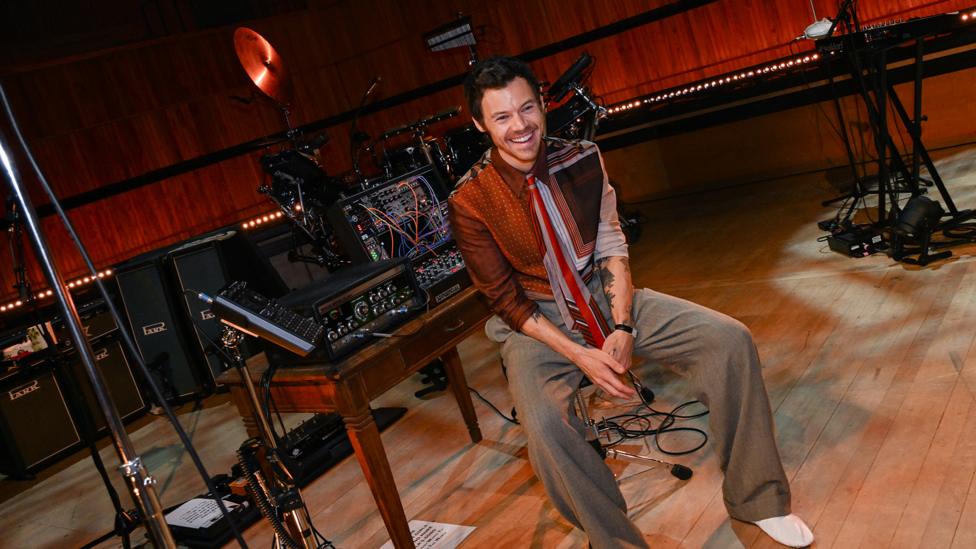 Image of Harry Styles smiling in the Live lounge.