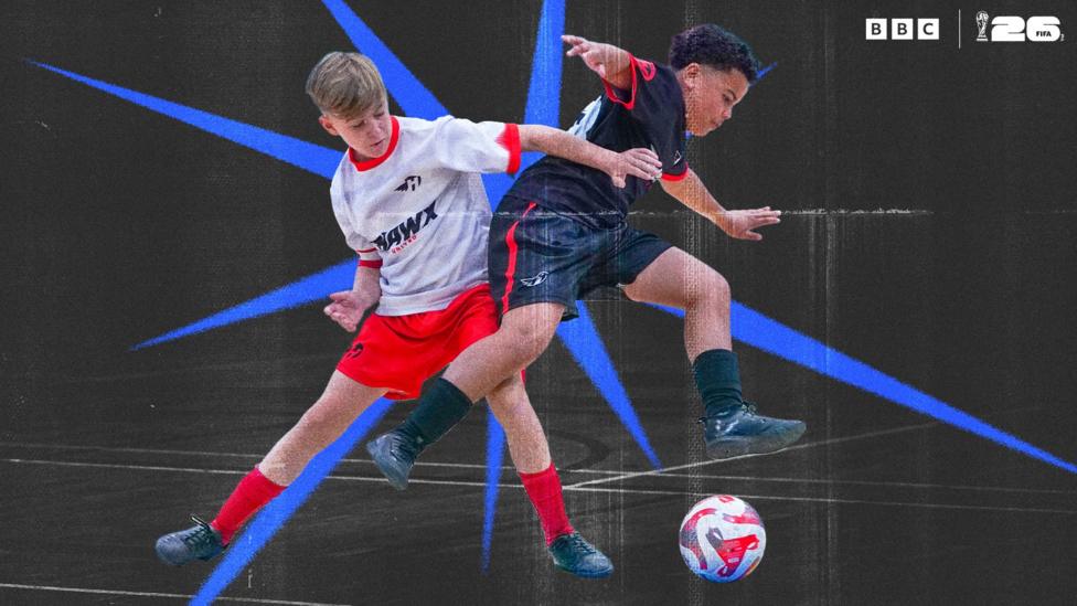 Two young footballers playing football and trying to get the ball