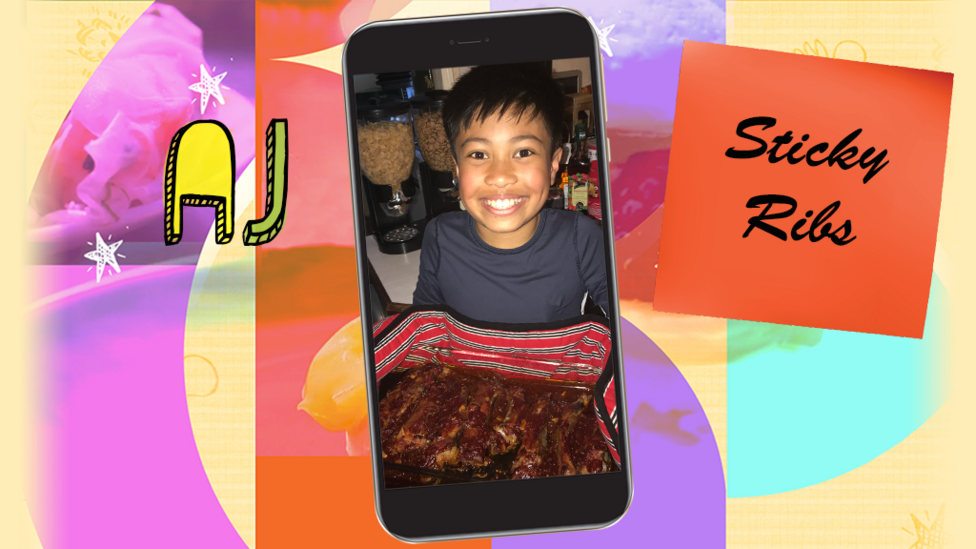 A little boy called AJ smiles as he holds up a tray of sticky ribs.