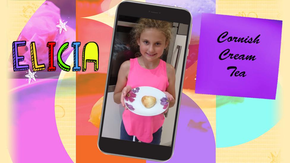 A girl (Elicia) showing off a heart-shaped scone on a plate.