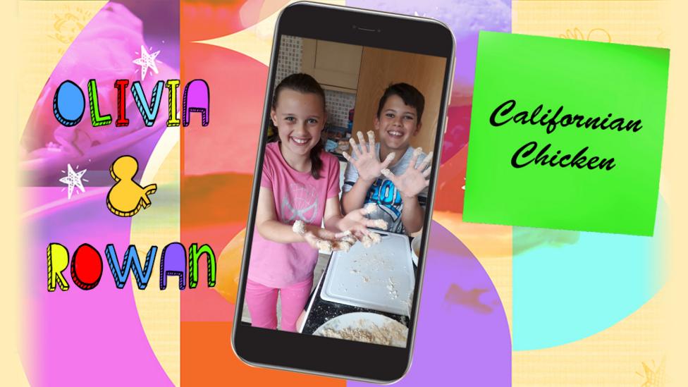 A little girl and a boy (Olivia and Rowan) grinning in their kitchen, hands covered in batter as they make Californian Chicken.