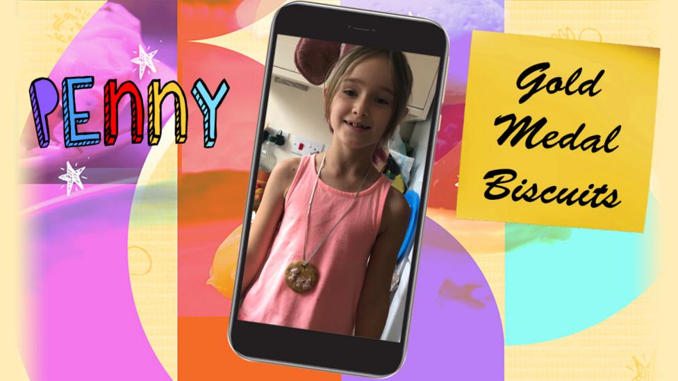 A picture of a little girl (Penny) wearing a gold medal biscuit around her neck on a ribbon.