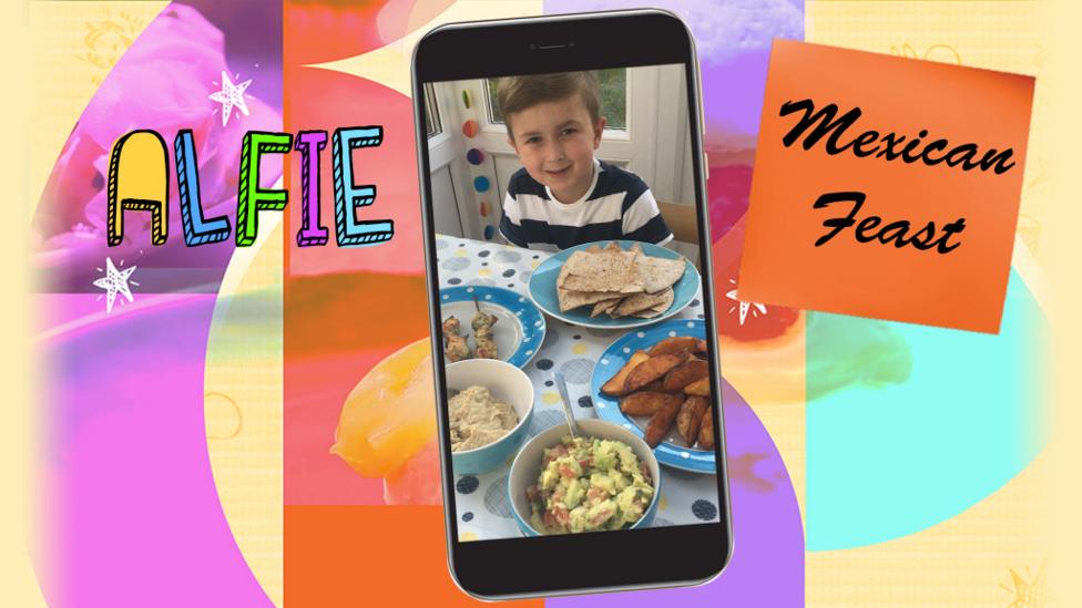A boy surrounded by plates of delicious food.