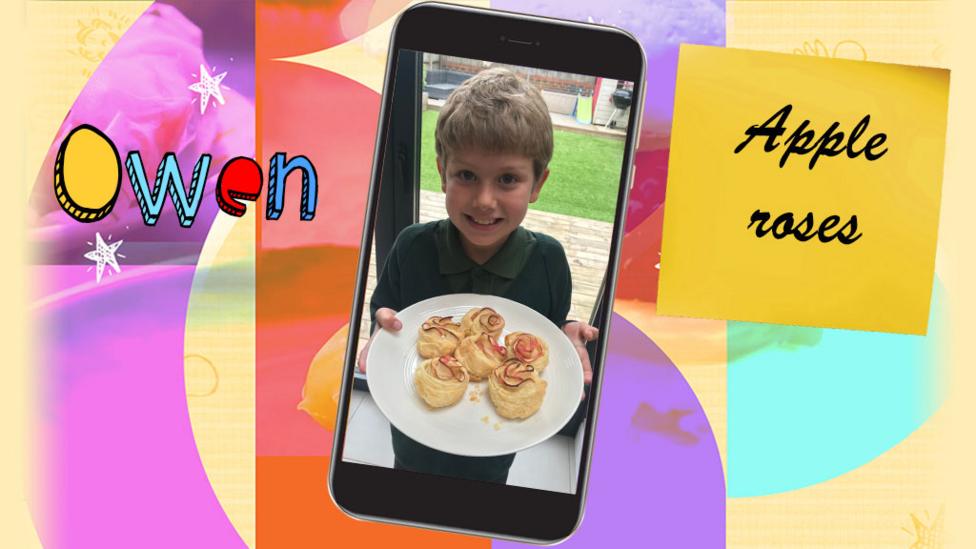 A boy shows a plate of the apple roses that he has made.