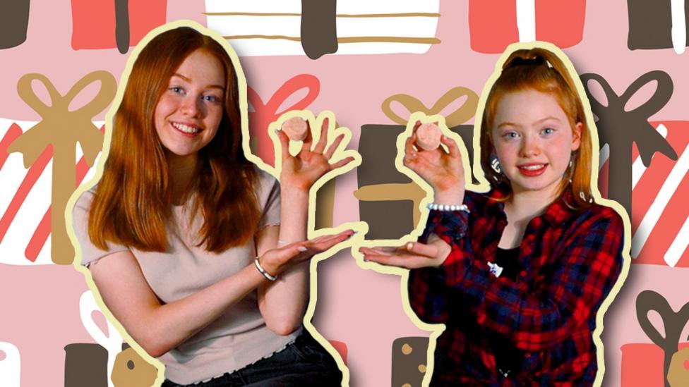 Sister's Ruby and Reylee are smiling whilst holding up small bath bombs.