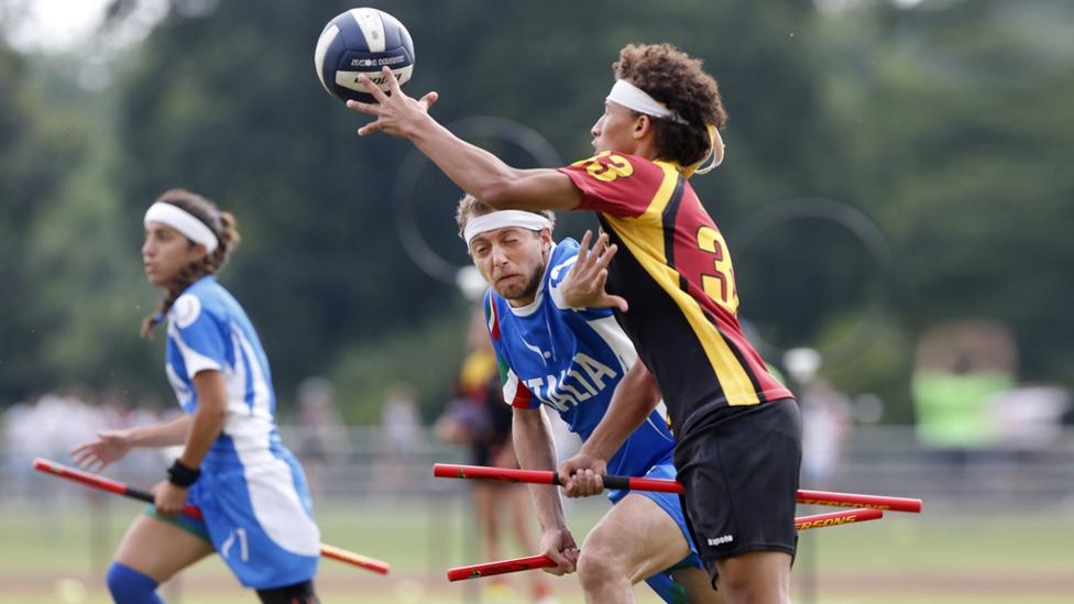 Two players challenging for the ball in a game of quidditch.