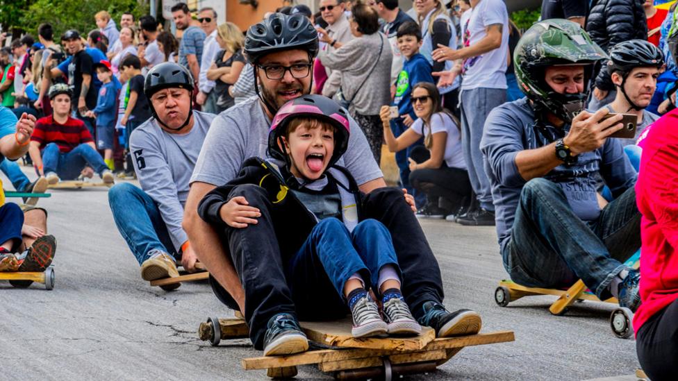 People racing in a street luge race in Brazil.