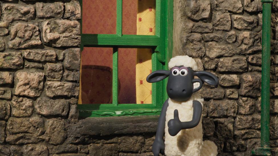 Image of a sheep giving a thumbs up outside a window of a house