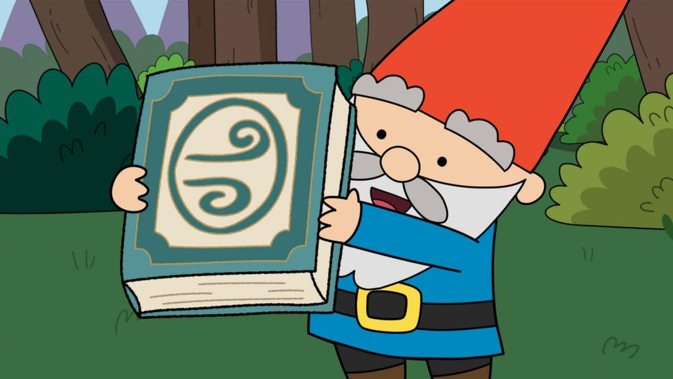 Image of a gnome holding a book stood in a forest.