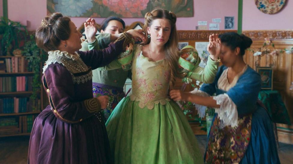 Lady Grace Cavendish wears a green dress and looks moody whilst her dressers work around her to get ready for the ball.