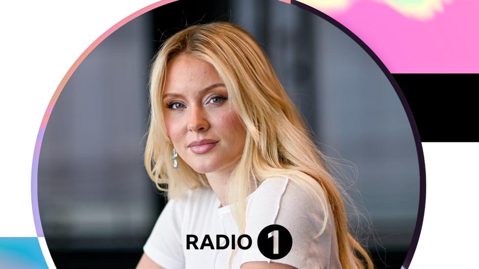 Zara Larsson leaning casually outside the Radio 1 studio.