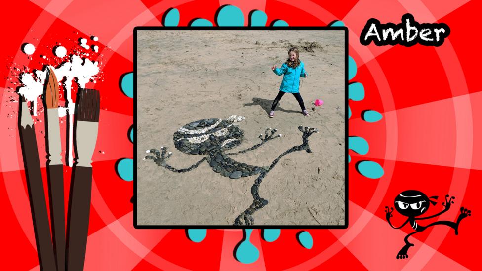 An Art Ninja character made in pebbles on a beach.