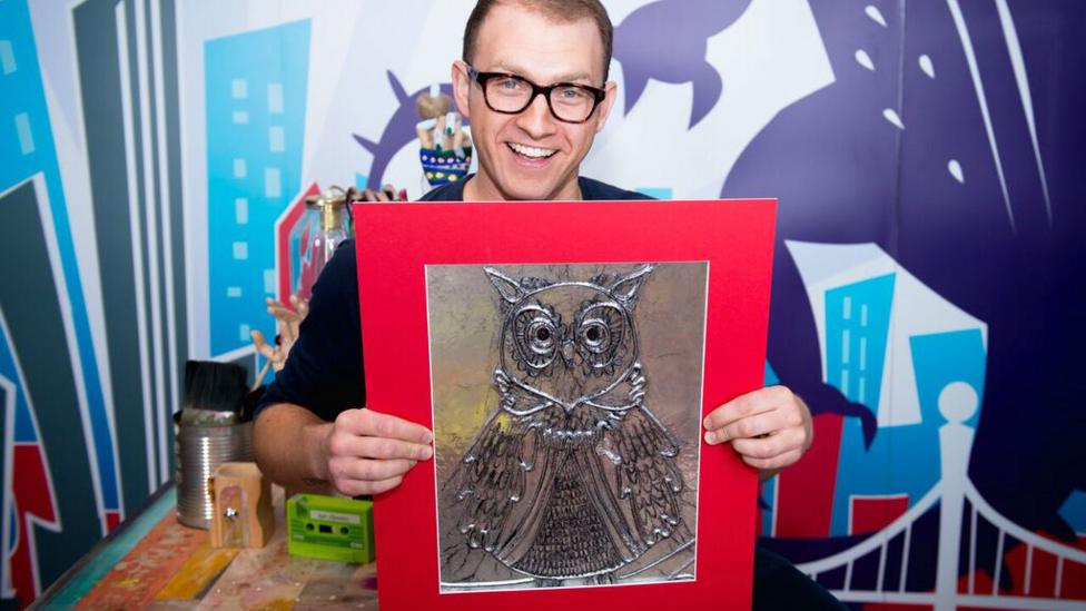 Ricky with an owl picture made out of tin foil.