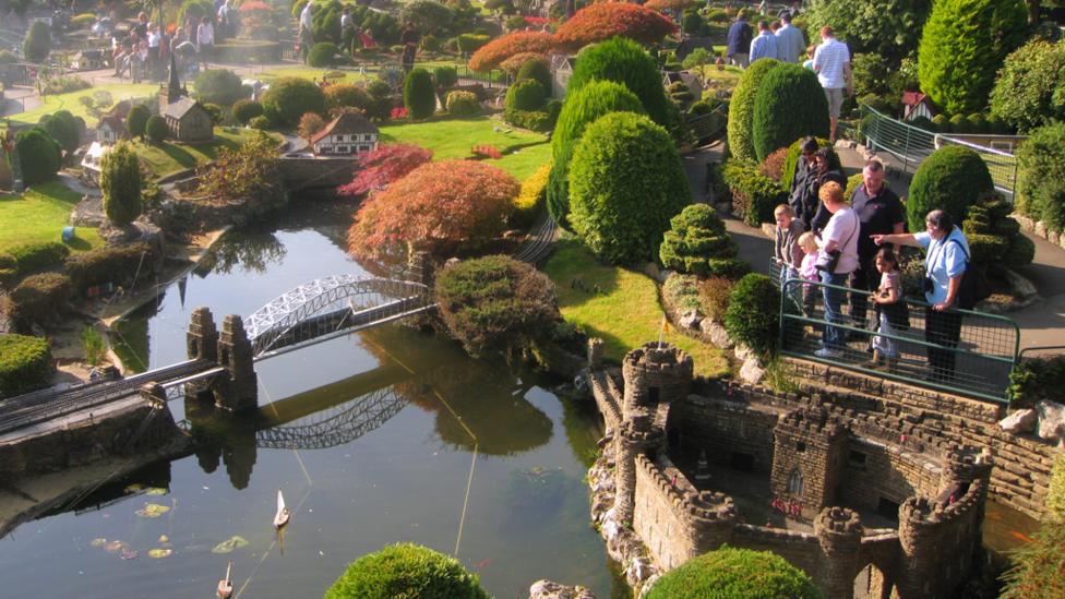 Families looking at the sites in the model village