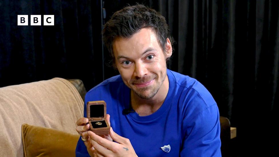 Harry Styles and his Gold Blue Peter badge.