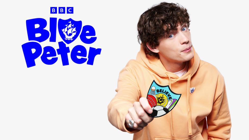 Joel holds a Blue Peter sport badge.