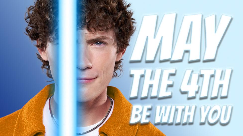 Joel with a lightsaber celebrating Star Wars day, May the 4th.