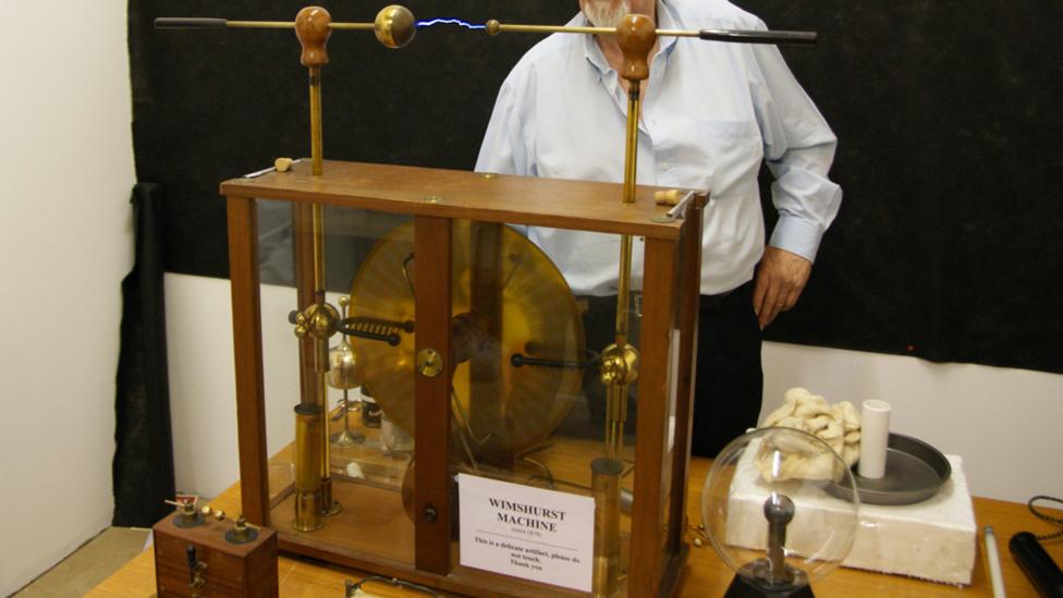 A man demonstrating the Wimshurst Machine