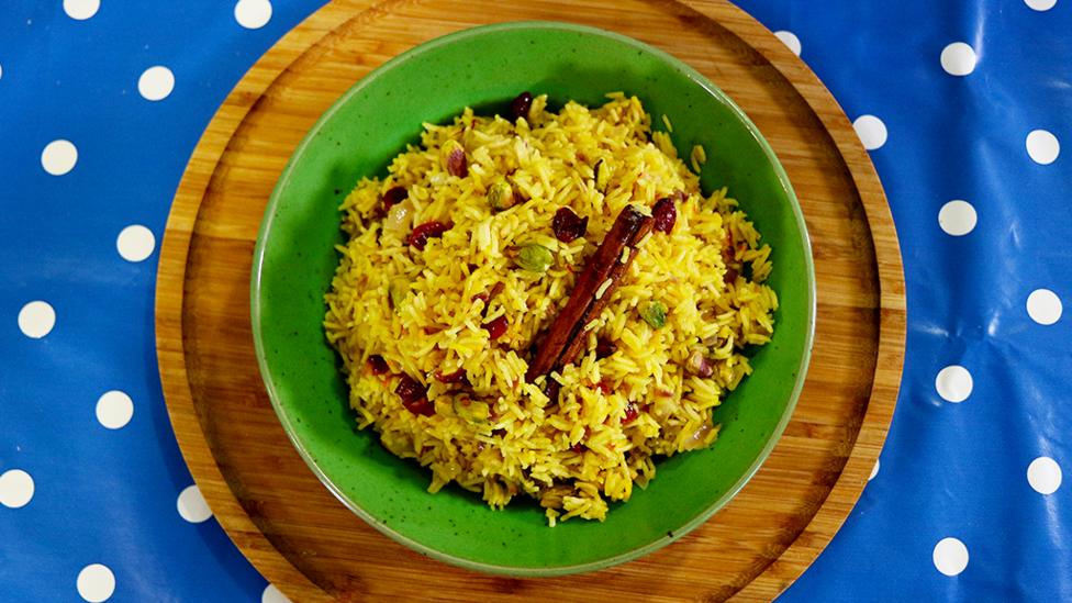 Biryani rice with pistachios and cranberries in it.