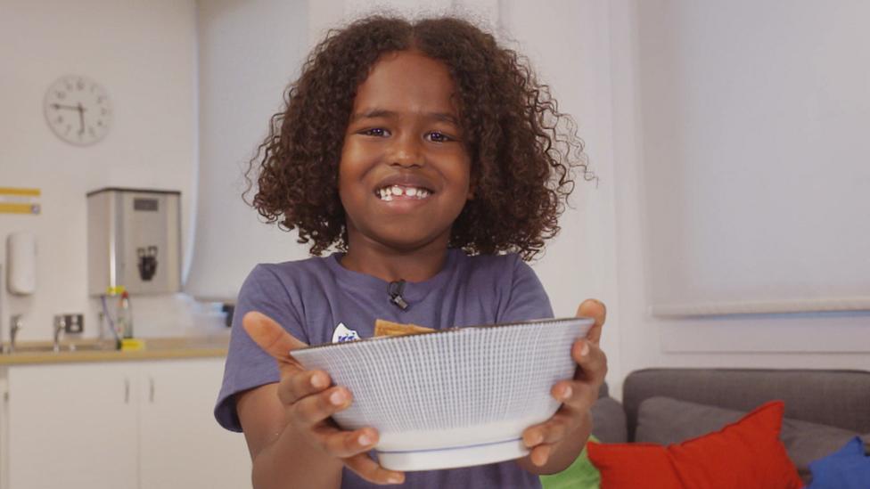 Somali Rice in a bowl, being held up by Laith.