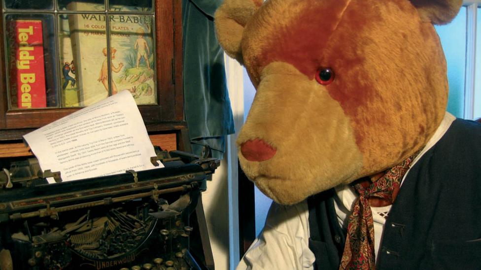 Mr Edward Bear sitting at his desk