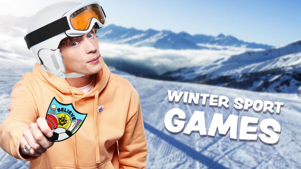 Joel holds a Blue Peter Sport badge on a ski slope.