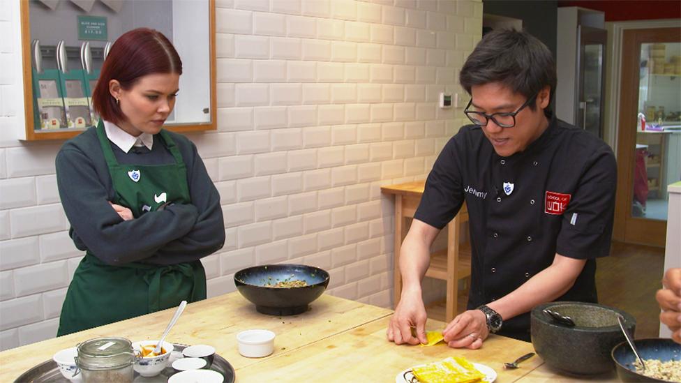 Jeremy Pang from School of Wok shows Lindsey how to fold the wonton.
