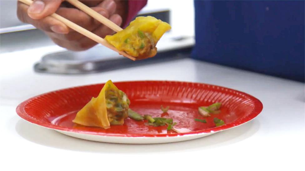 Wontons on a red plate.