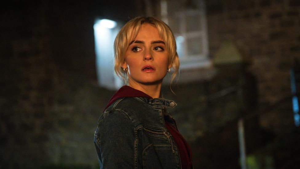 Ruby Sunday from Doctor Who looks worriedly at something off screen.