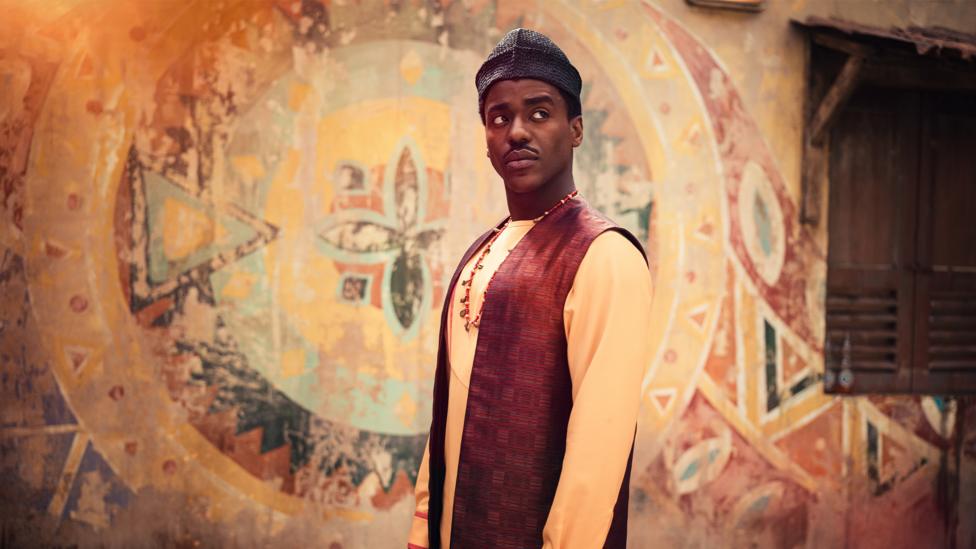 The Doctor, wearing traditional Nigerian clothing.