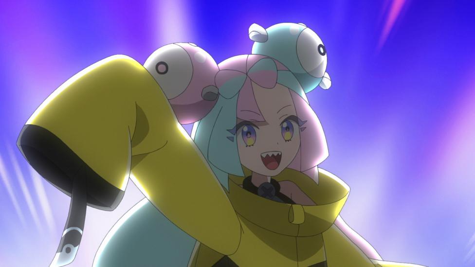 Gym Leader Iono, she is a young girl with blue and pink hair and a large yellow coat.