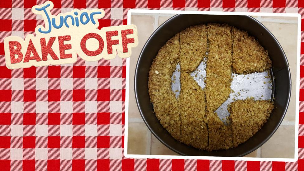 Flapjack in a round tin in the shape of the CBBC logo.