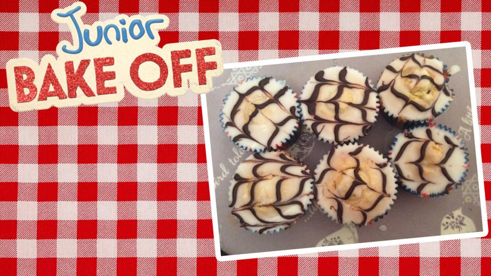 Cupcakes with a white and milk chocolate feathering pattern on top.