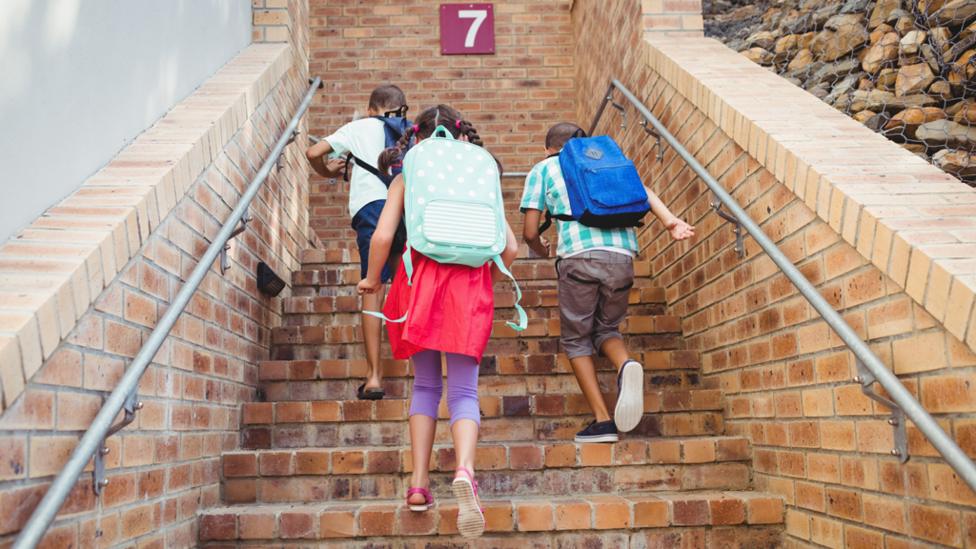 School kids walking upstairs
