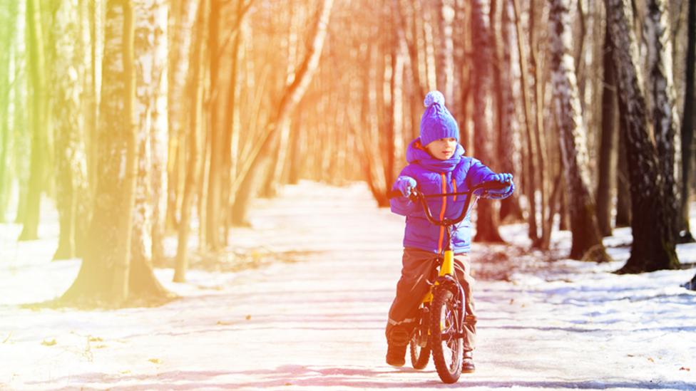 Boy writing bike in the snow