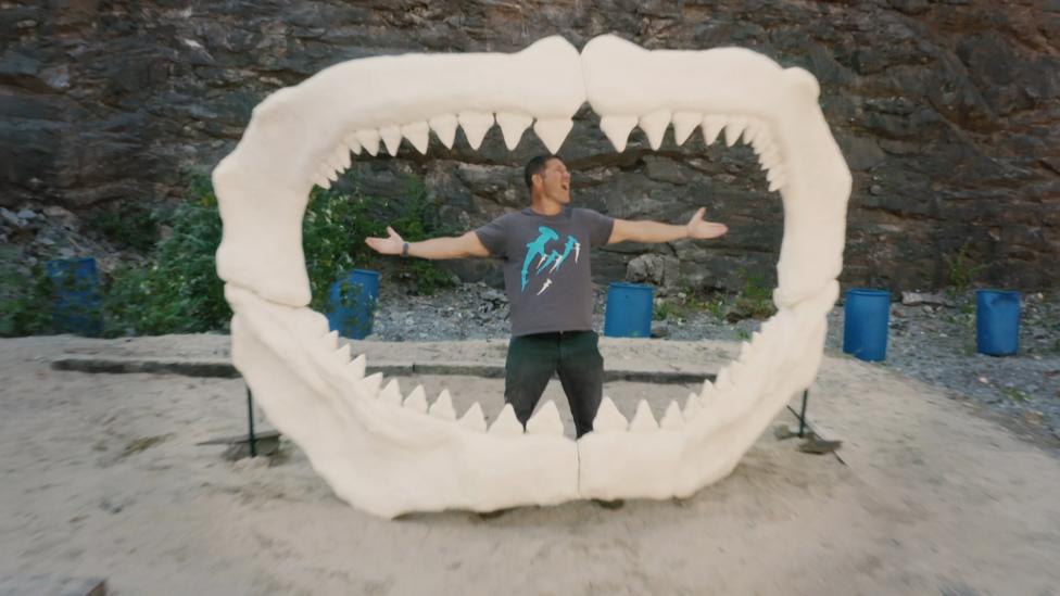 Steve standing inside the jaws of a megalodon.