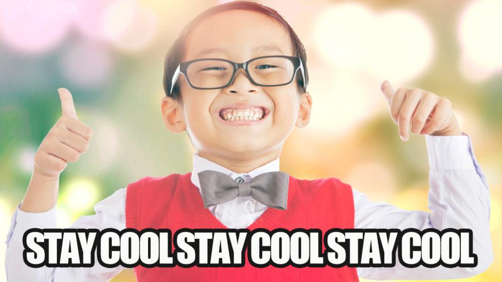 A boy wearing a tie and red jumper is grinning, thumbs up, with a caption that reads 'Stay cool stay cool stay cool'.